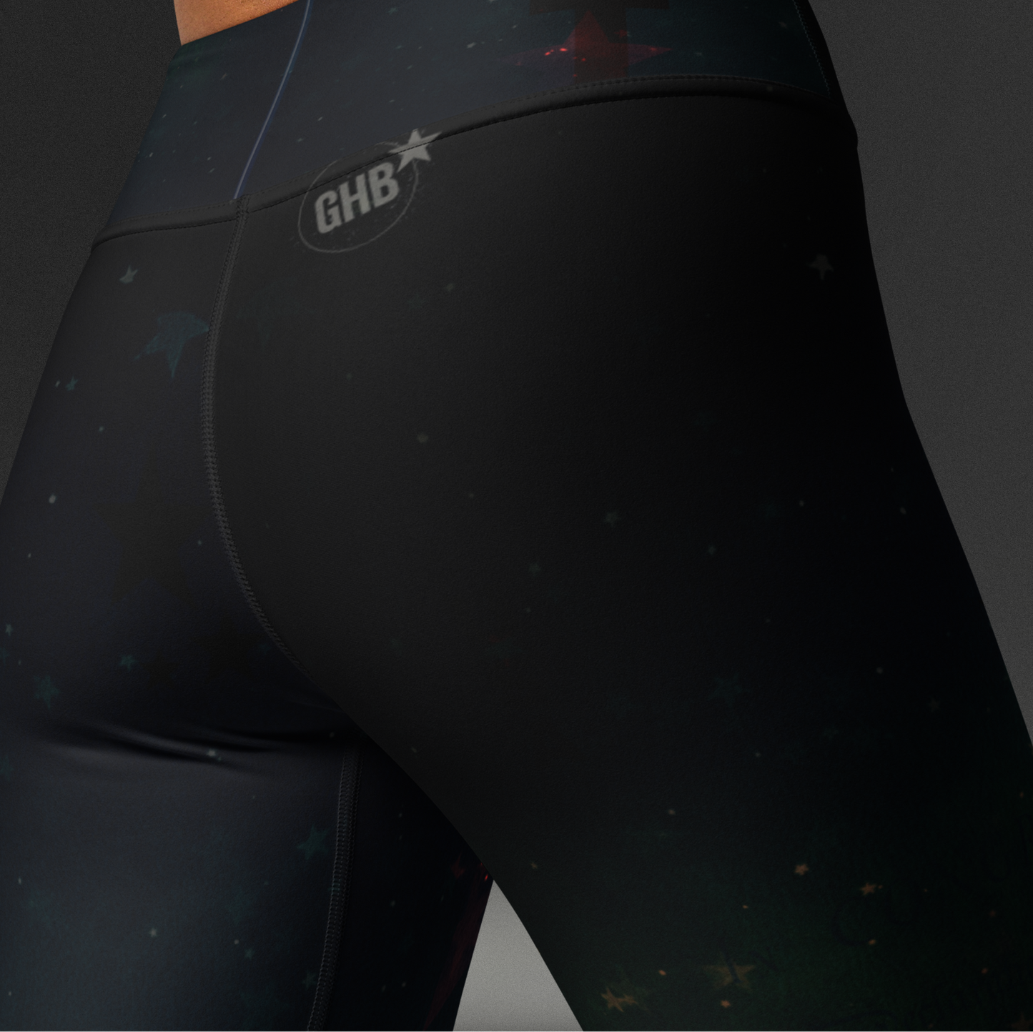 Black athletic leggings with a brand logo on a dark background, Stars and subtle words.
